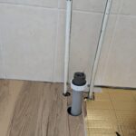 Installing vinyl laminate planking in a bathroom in worthing, cutting out hols for pipe work