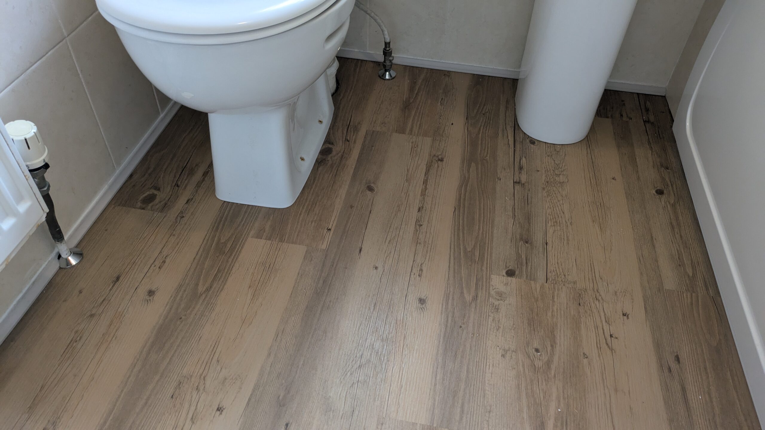 Picture of a bathroom in Worthing, the old floor has been replaced with vinyl laminate planks including sub-floor