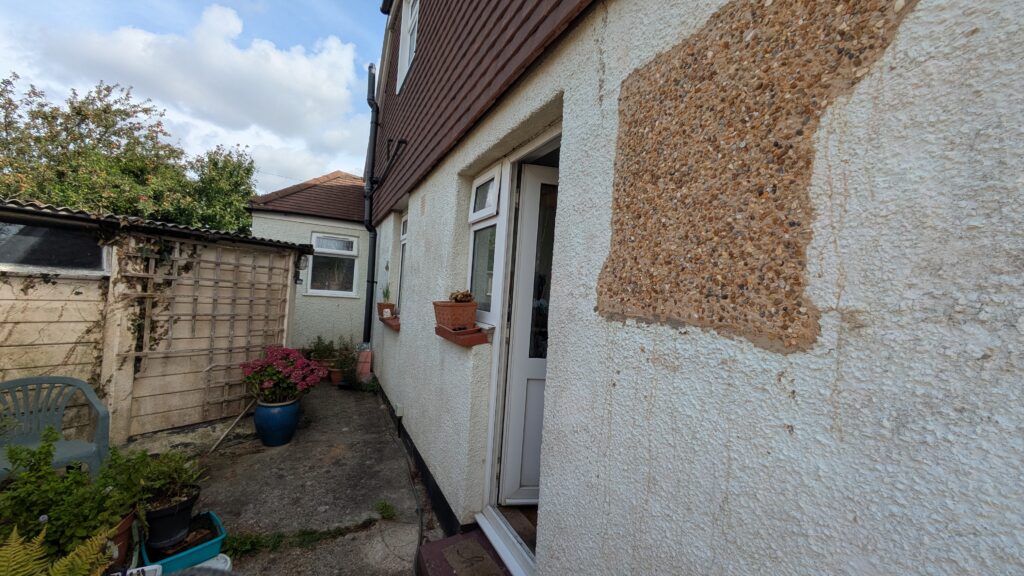 Repaired pebble dash exterior, unpainted on a bungalow in Tarring, worthing