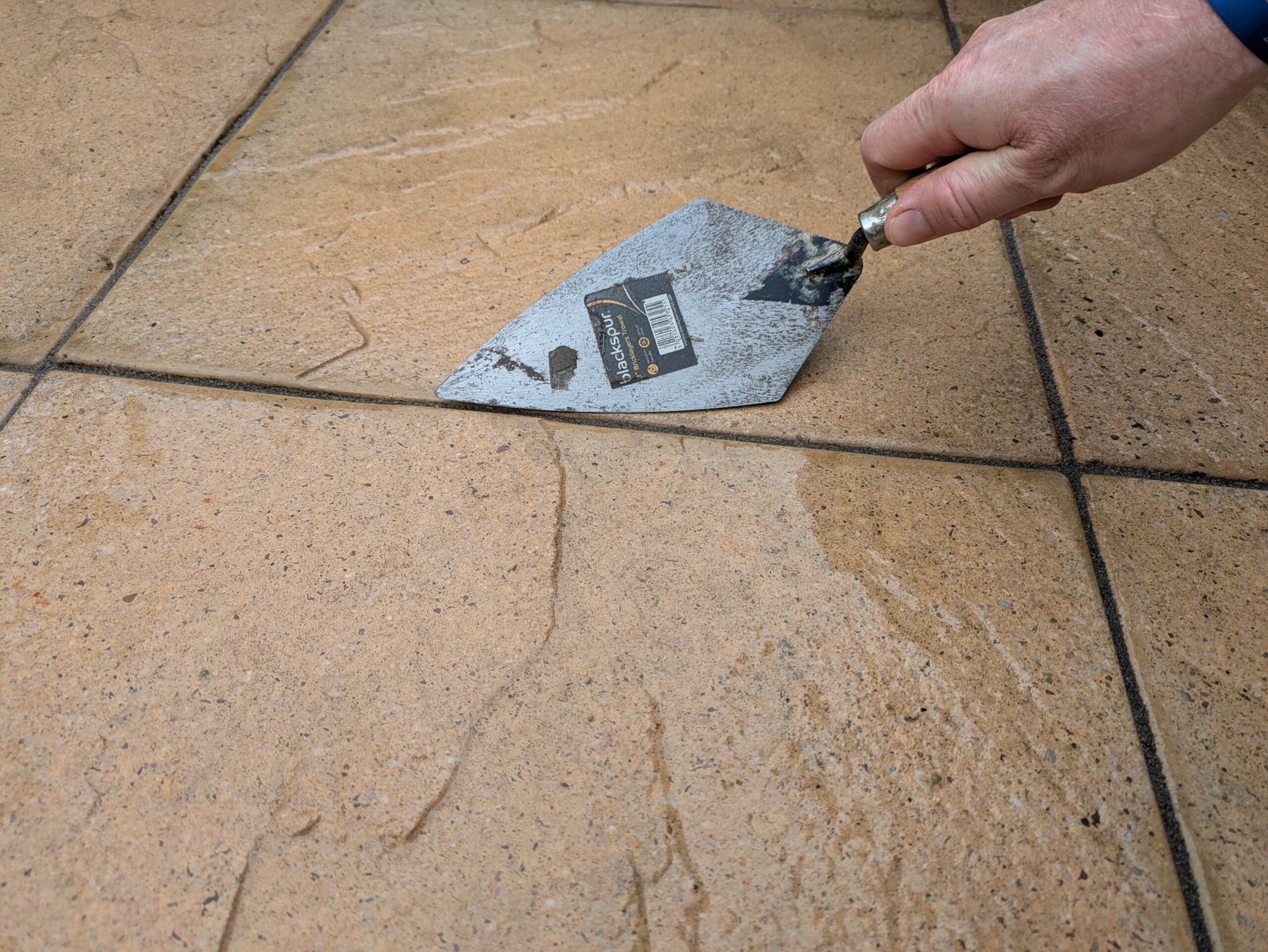 Repointing a patio in Worthing with long lasting resin using a trowel