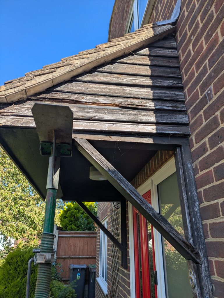 rotten support timbers and rotten shiplap cladding on a wooden porch repair job