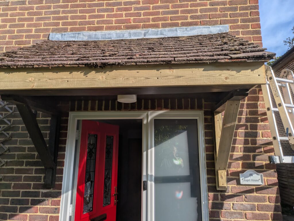 wooden porch repair new facia and support timbers ready to stain