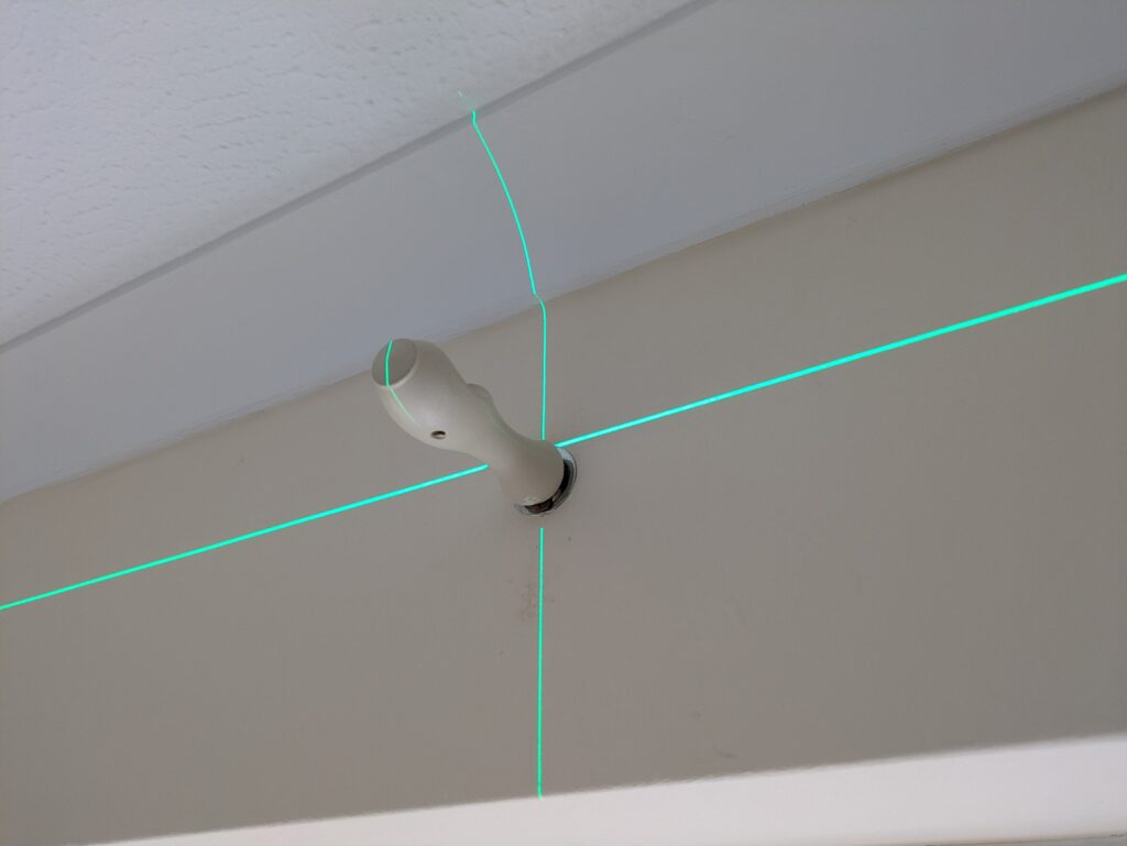 Using a laser level to ensure a perfectly straight and level curtain rail in Worthing