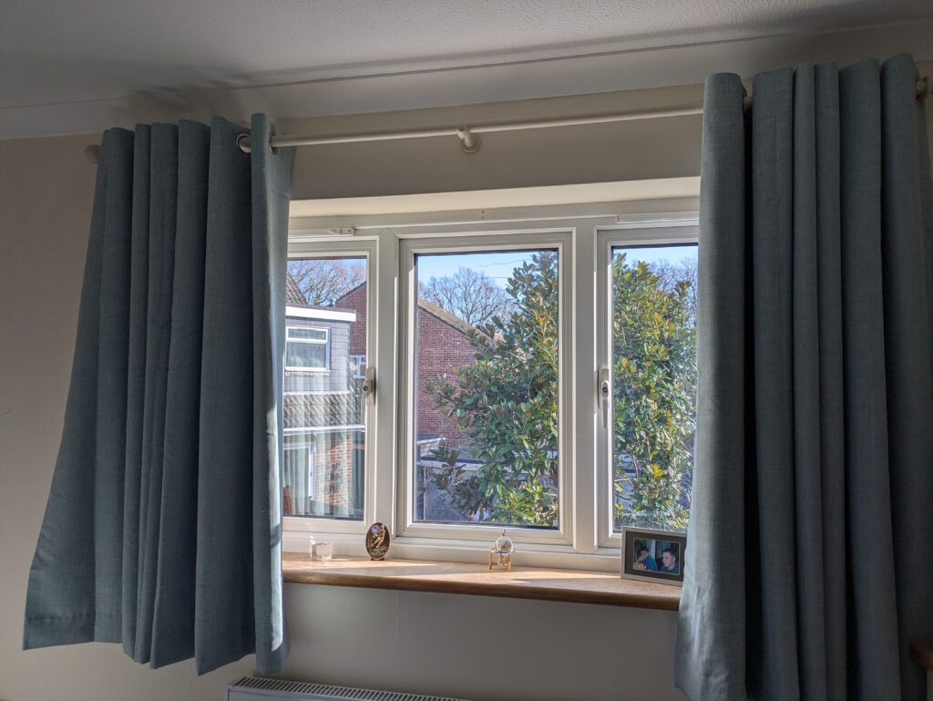 Hanging a curtain rail, newly hung and open curtains Worthing